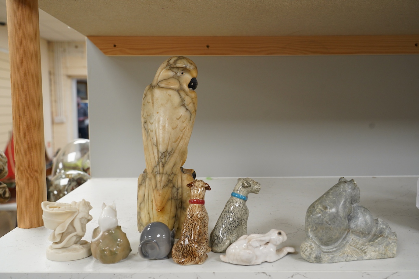 A carved alabaster parrot, a stone carving of two mice, two Royal Copenhagen mice, a mouse spill vase, a pair of dog pepperettes and a hare ornament, tallest 26cm high (8). Condition - small chip to ear of white Copenhag